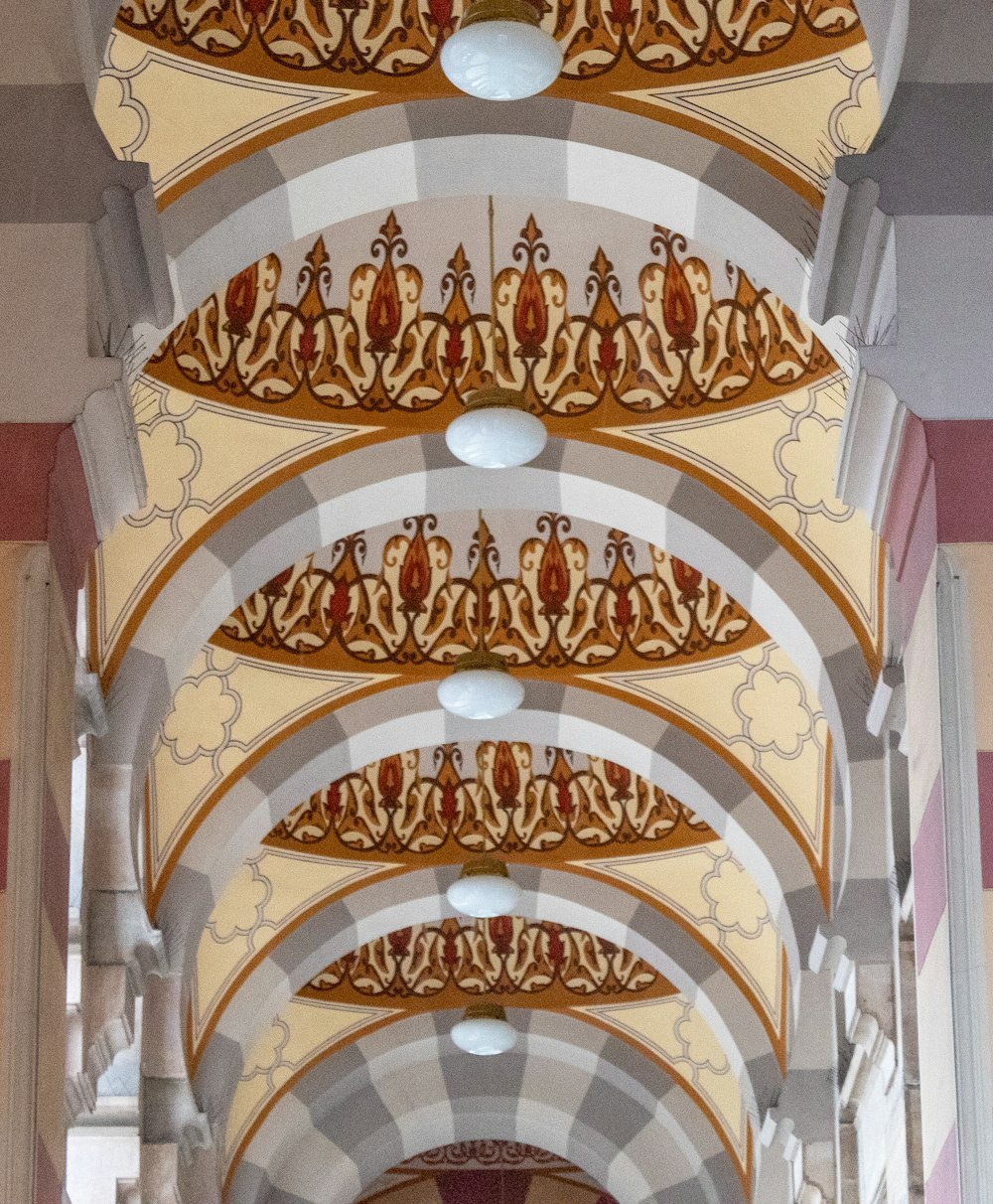 the ceiling of a large building has intricate designs on it