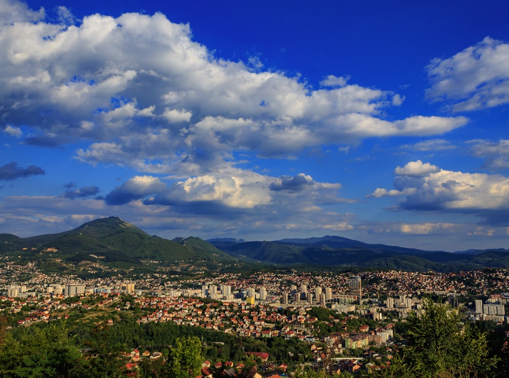 a view of a city with mountains in the background