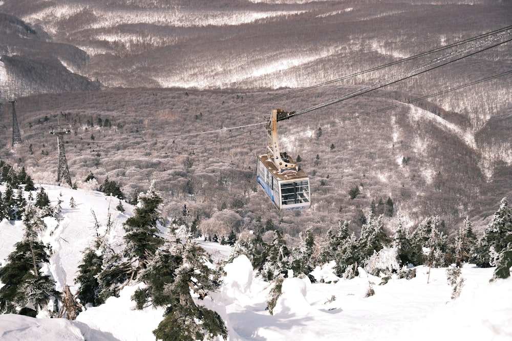 a person riding a ski lift on a snowy mountain
