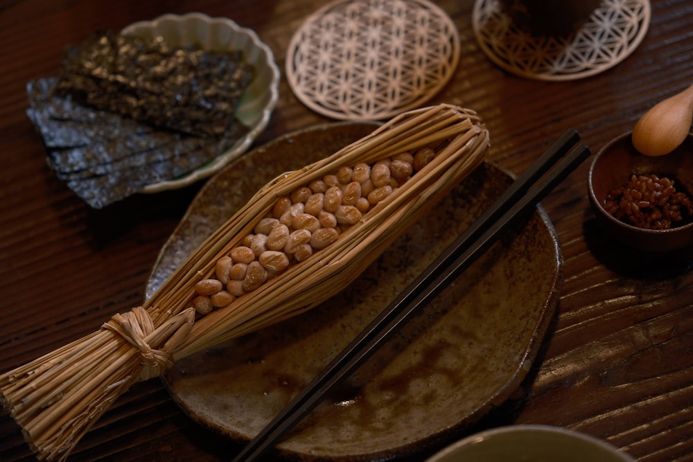 a wooden table topped with plates and bowls filled with food