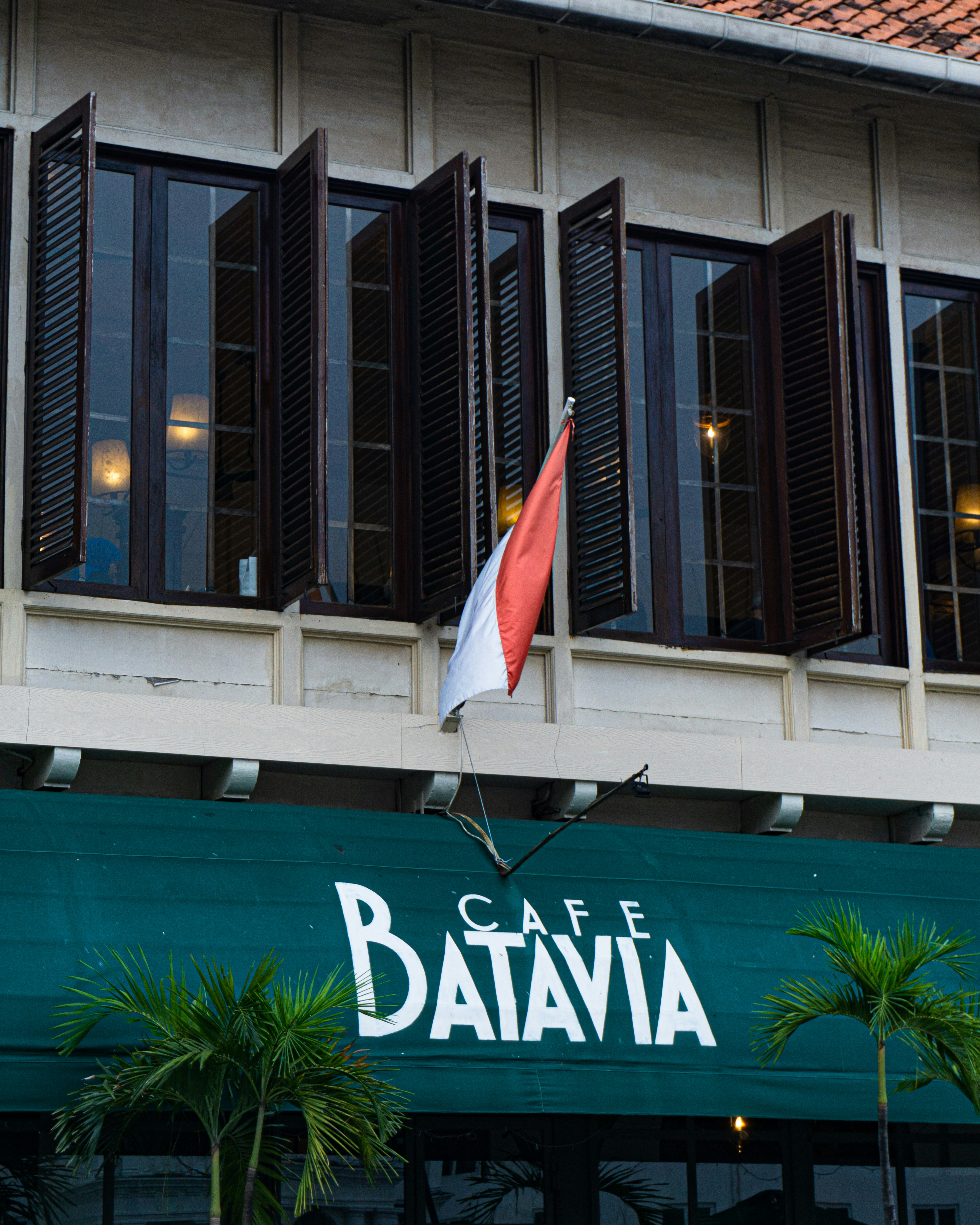 a building with a flag hanging from the side of it