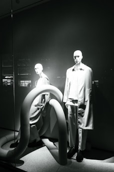 Modern fashion pieces displayed on minimalist mannequins.