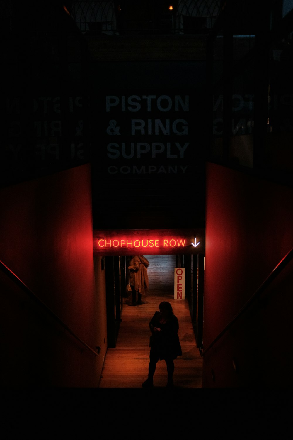 a person is standing in a dark hallway