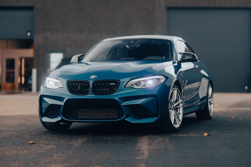 a blue car parked in front of a building