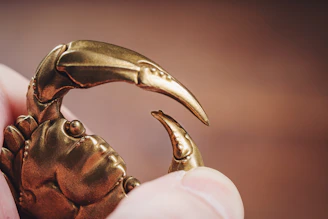 Close-up of a customer’s hand holding a beautifully crafted scrap metal sculpture.