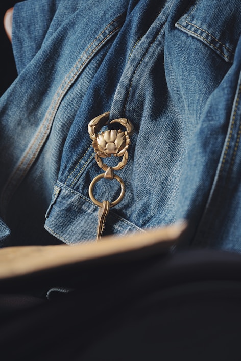 Close-up of a delicate crochet keychain shaped like a tiny leaf with soft natural lighting.