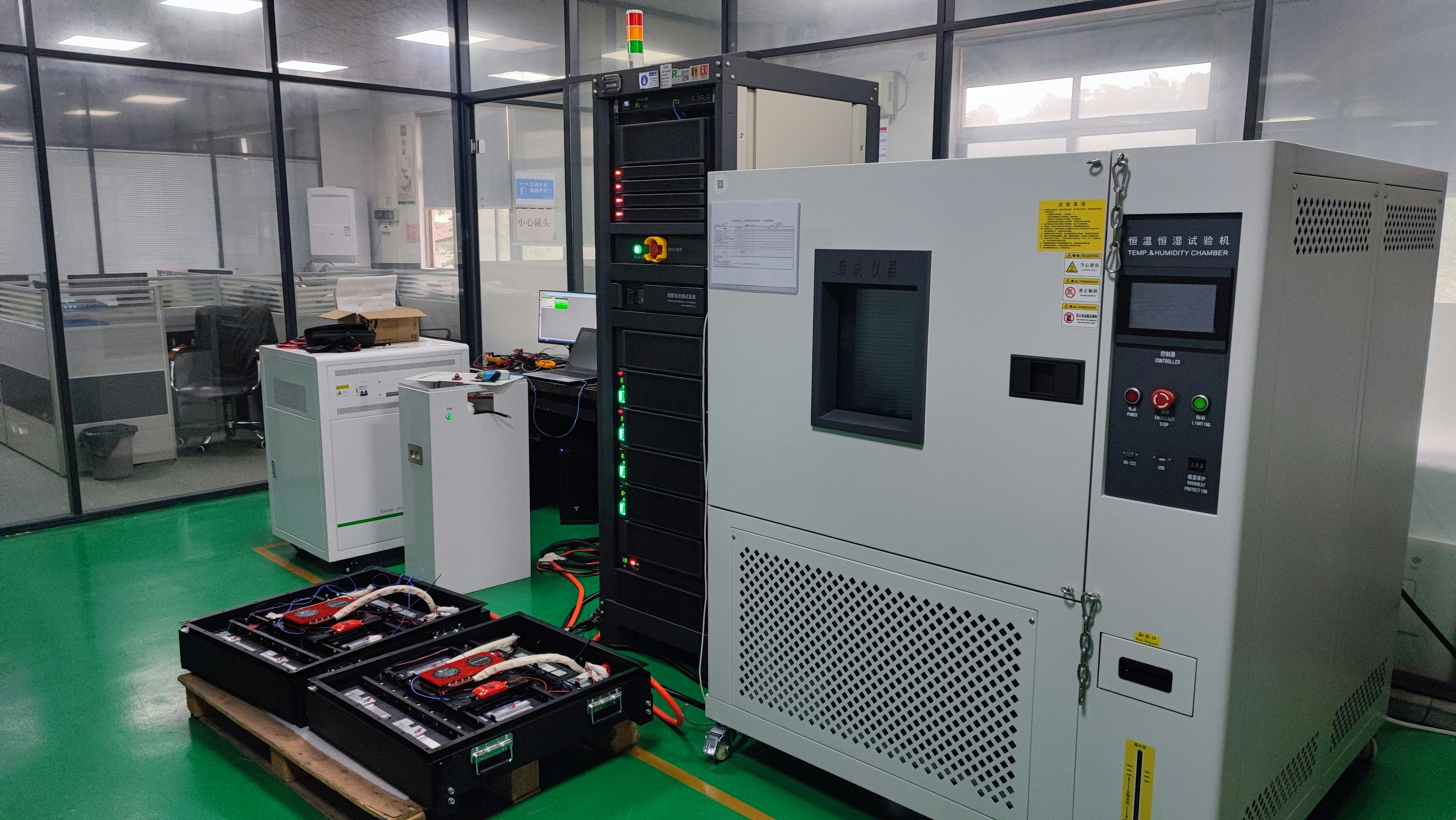 Battery testing station with power meters and thermal monitoring equipment for device endurance testing