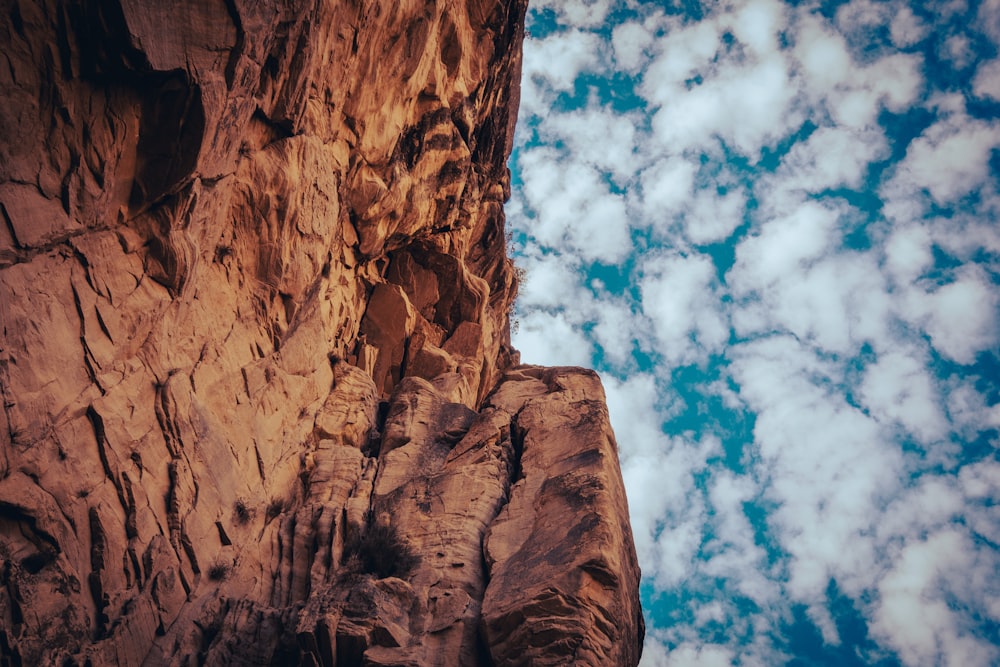 a rocky cliff face with a sky background