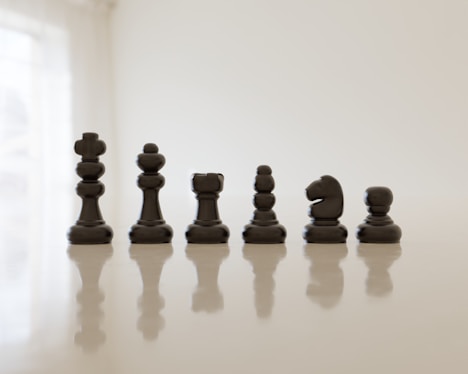a set of chess pieces sitting on top of a table