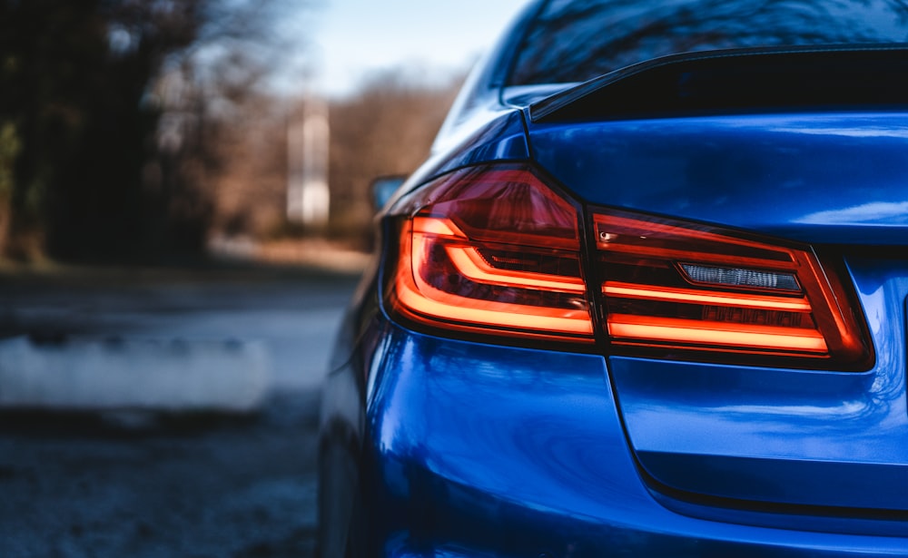 a close up of the tail lights of a blue car