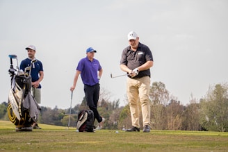 A group of men enjoying a golf tournament, fostering friendship and support.