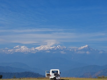A spacious SUV parked in front of a mountain cabin, inviting adventure.