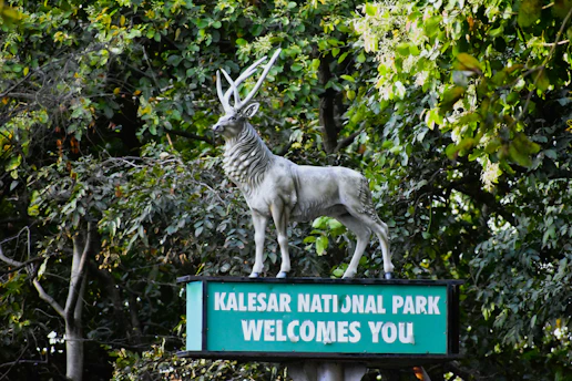 a statue of a goat on top of a welcome sign