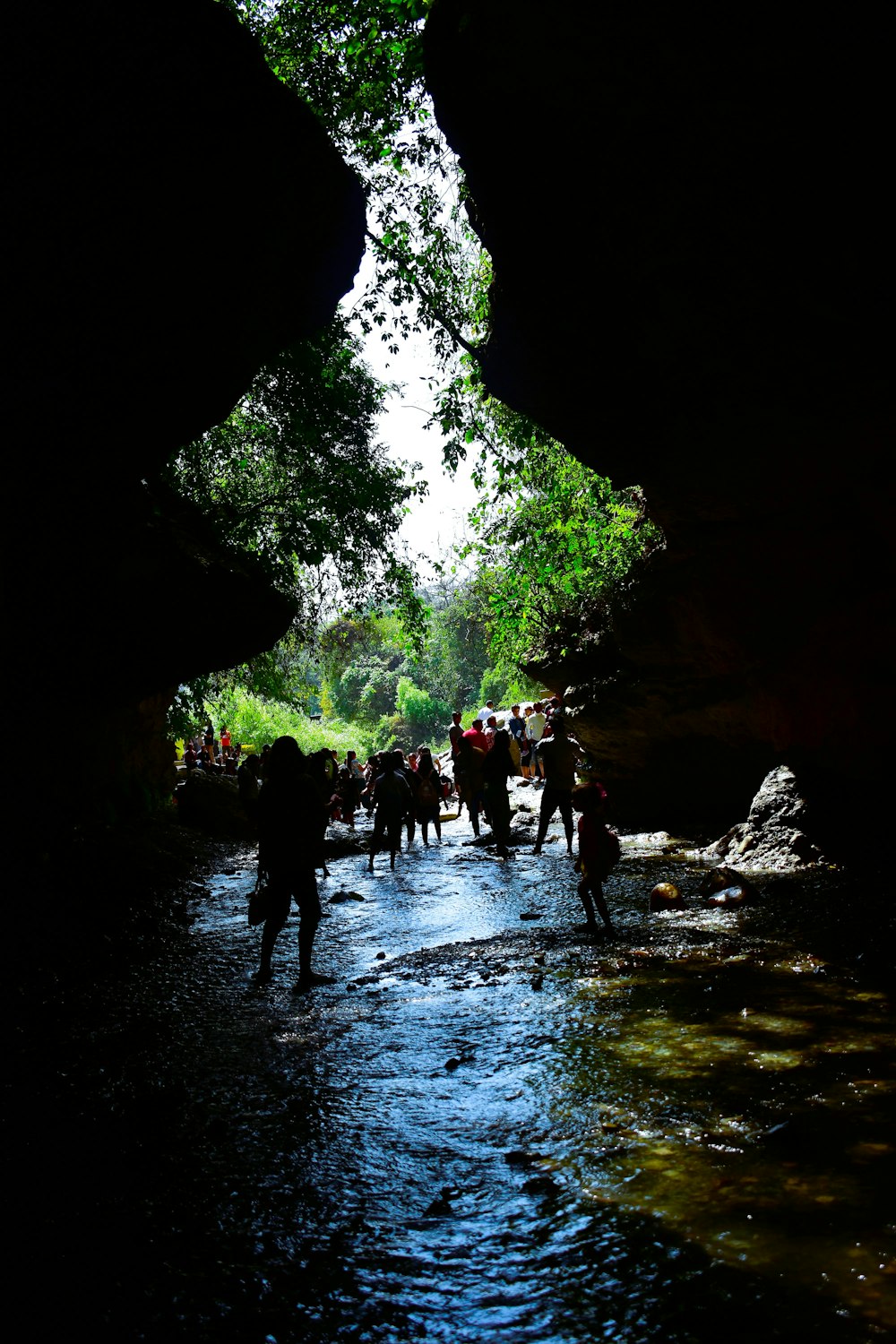 a group of people walking through a cave