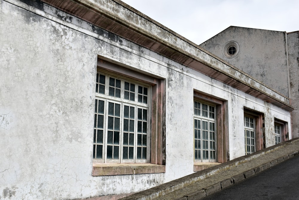 an old building with three windows and a steeple