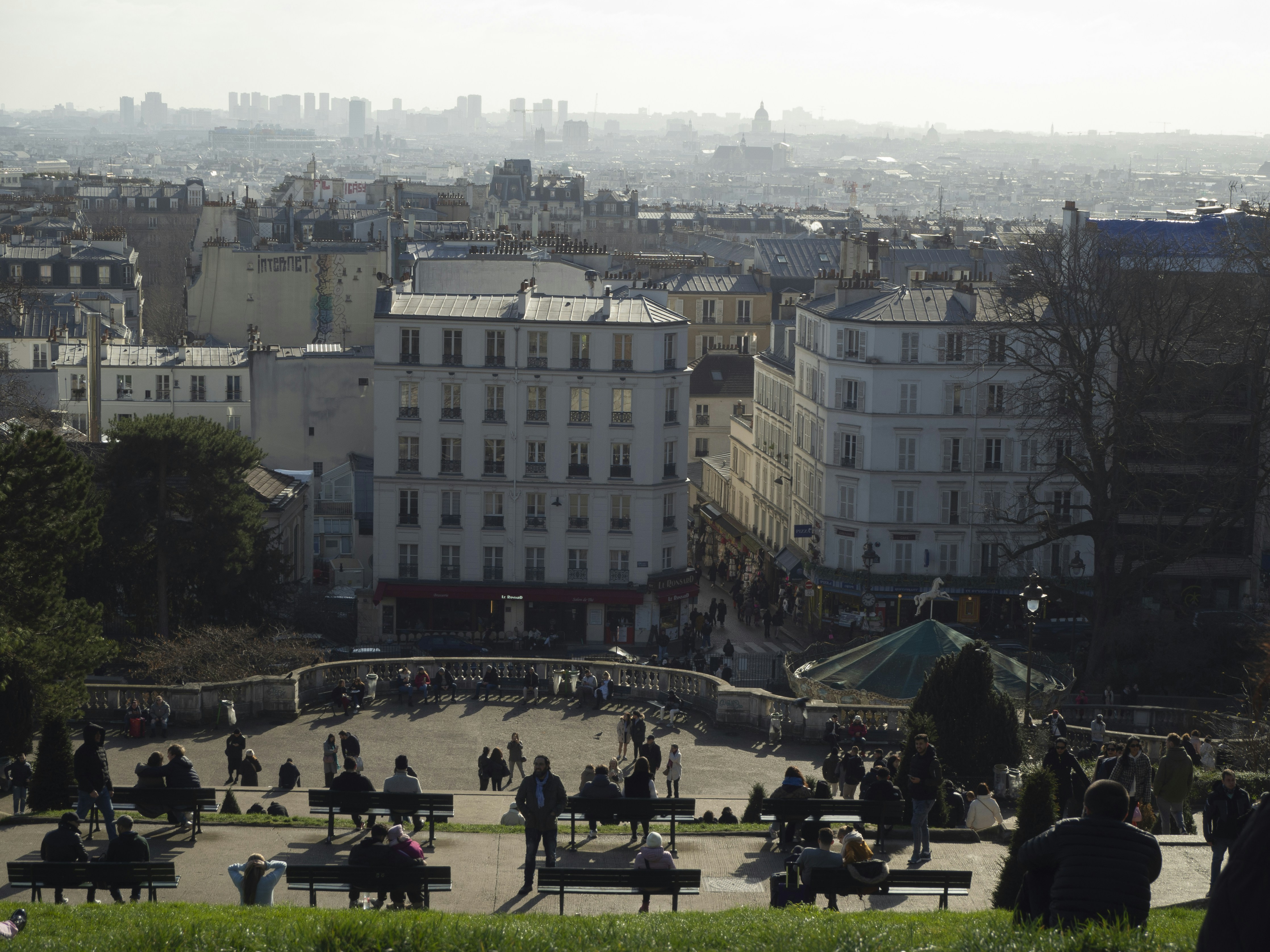 Stop image for Desert Escape: 3 Days from Las Vegas to Red Rock Canyon - a group of people sitting on top of a lush green hillside -  in Southwestern Nevada - Photo by Lizixi Zhu on Unsplash