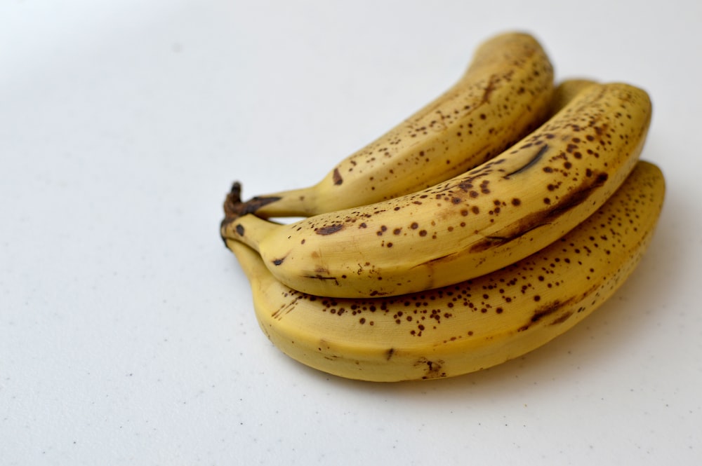 a bunch of ripe bananas sitting on top of a table