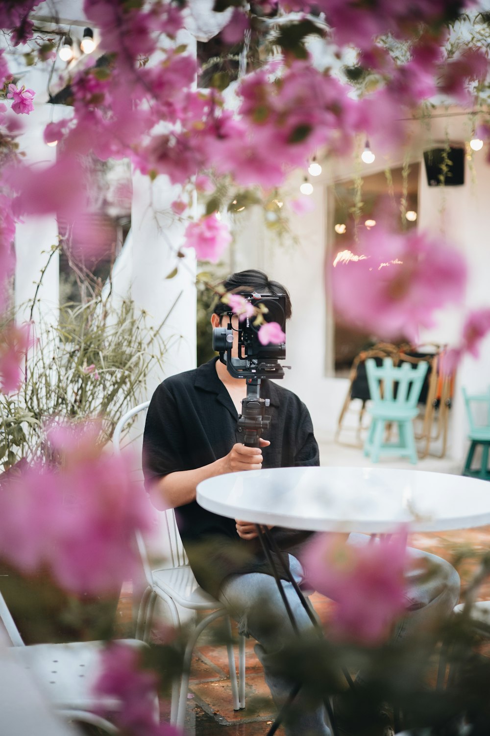 a man sitting at a table with a mask on his face