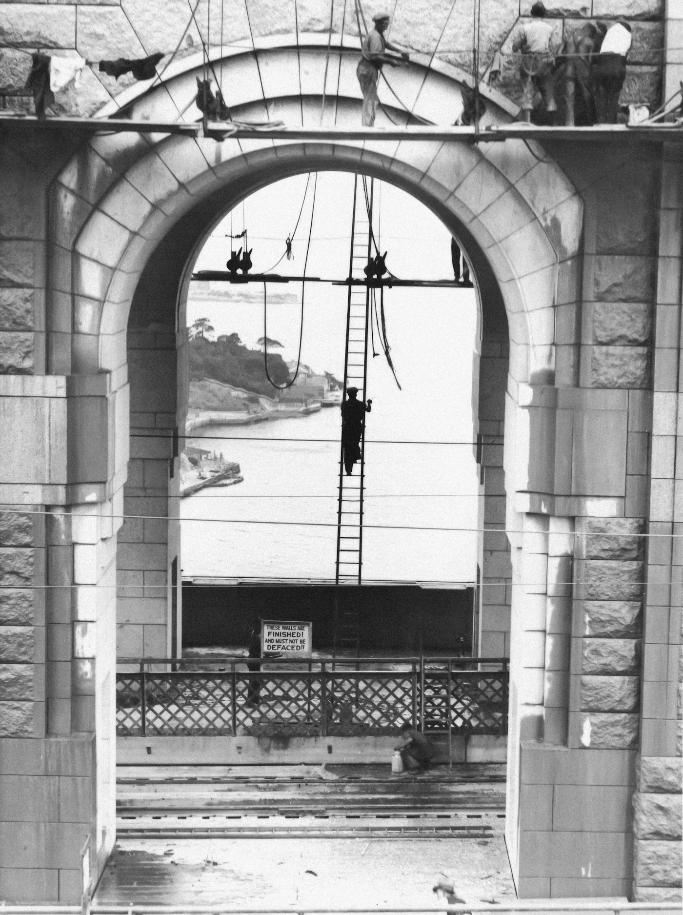Black and white image of a train crossing a bridge in Sydney