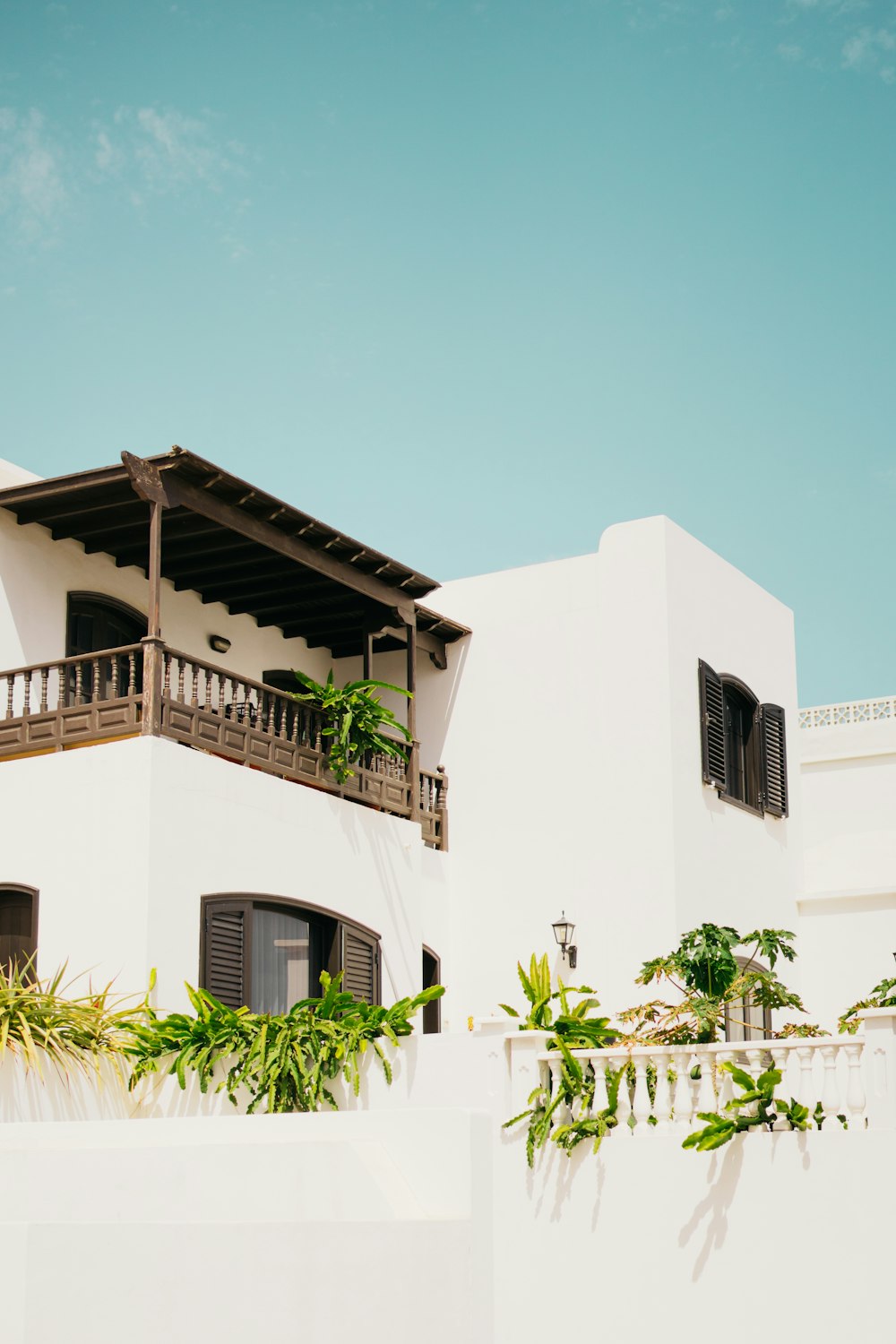 a large white building with a balcony and balconies