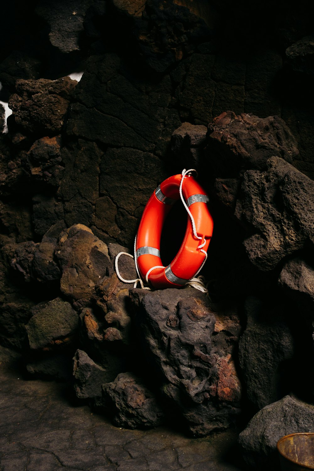 a life preserver sitting on top of a pile of rocks