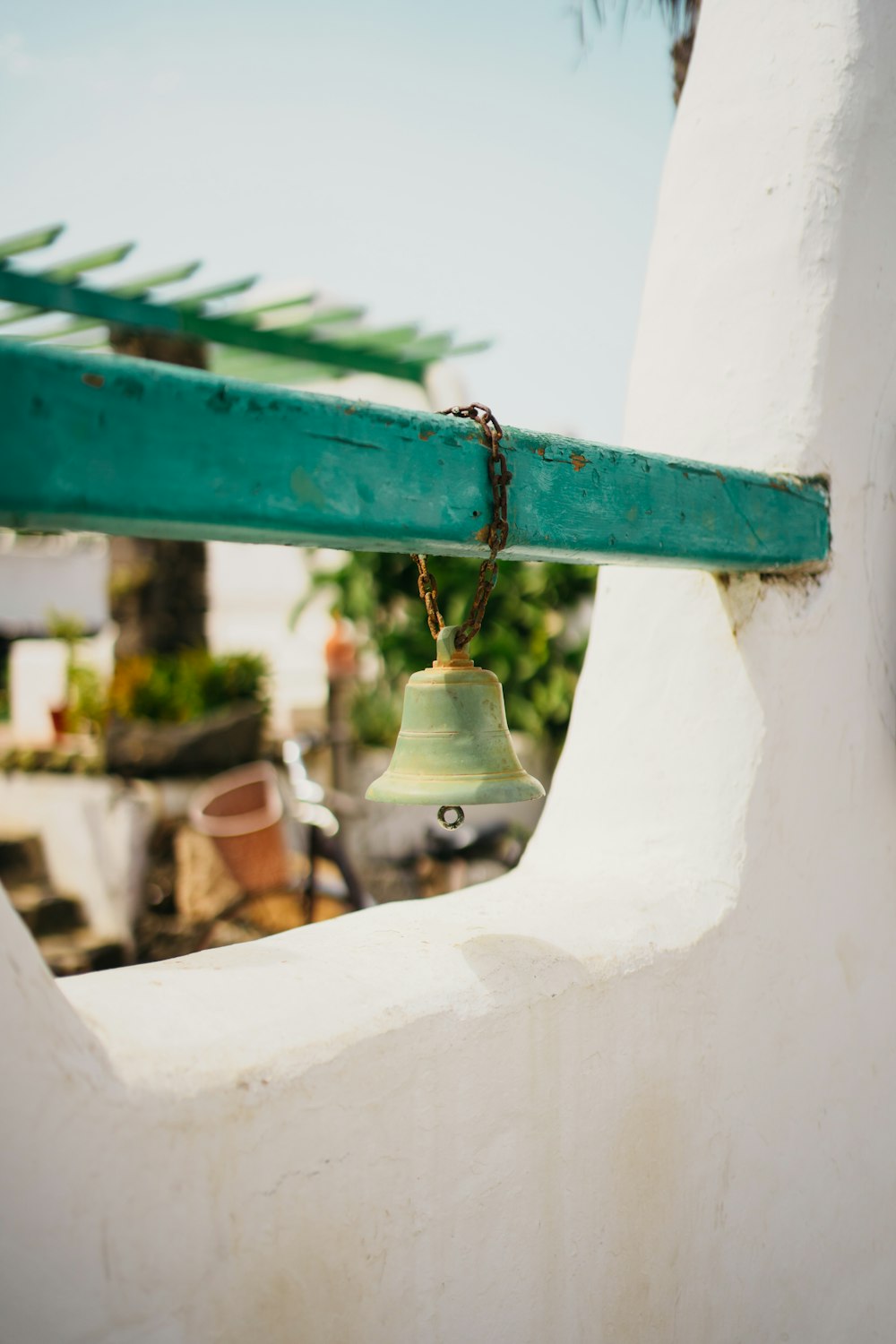 a bell hanging from the side of a building