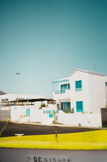 Exterior view of pousada Riviera Changryla showing clean white walls and orange accents