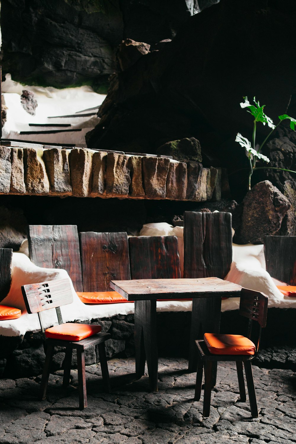 a couple of chairs sitting next to a wooden table