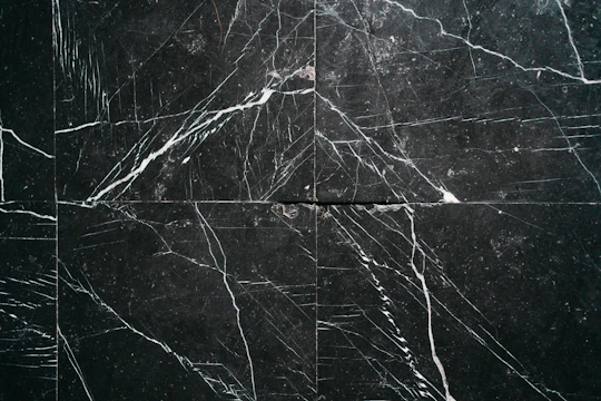 a black marble tile with white lines on it