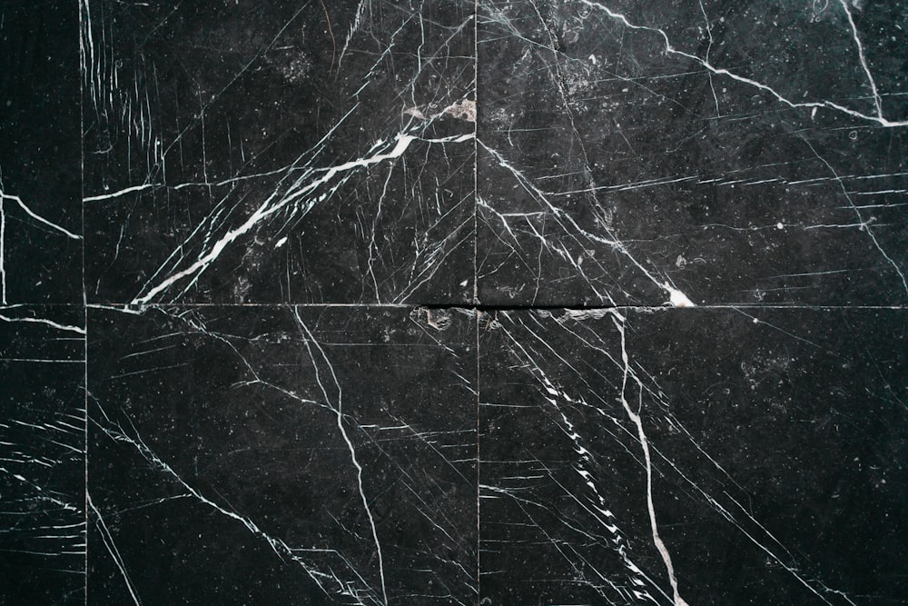 a black marble tile with white lines on it