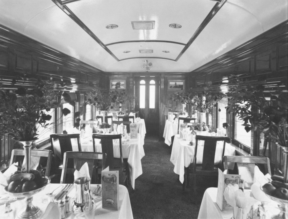a black and white photo of a dining car