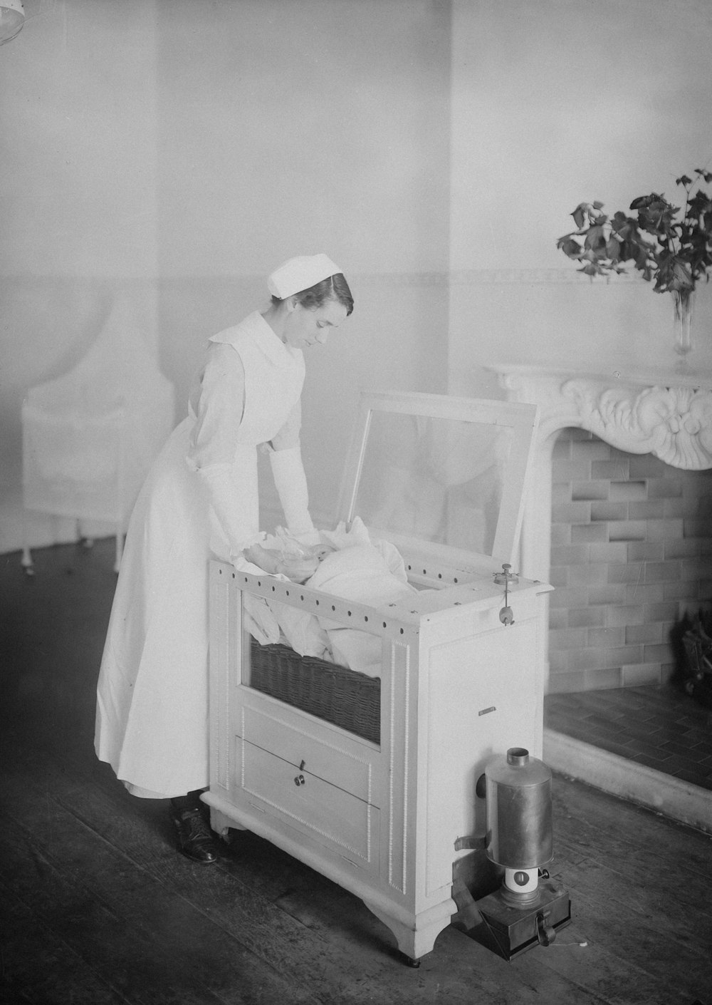 a woman in a white dress and hat standing in front of a chest of drawers