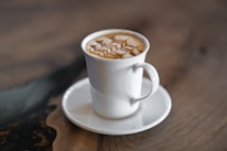 Close-up of a beautifully crafted specialty coffee cup on a wooden table.