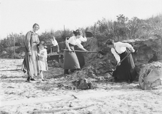 A diverse group of women engaged in a community service project outdoors.