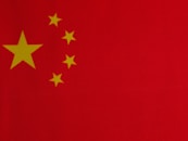 a close up of a red background with yellow stars