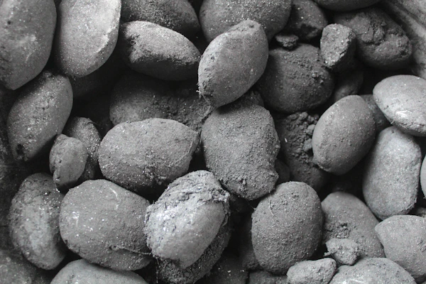 Close-up of premium charcoal briquettes neatly stacked in a clean, modern setting