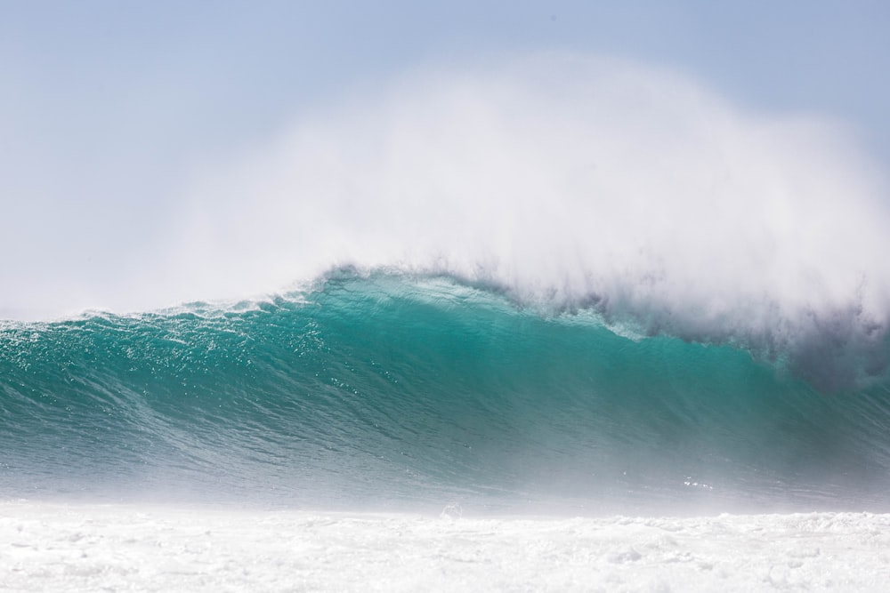 a man riding a wave on top of a surfboard