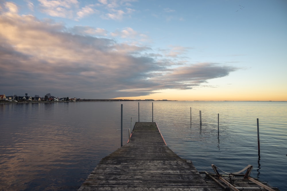 a long dock sitting on top of a body of water