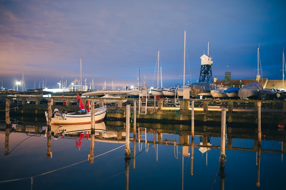 a boat is docked at a marina at night