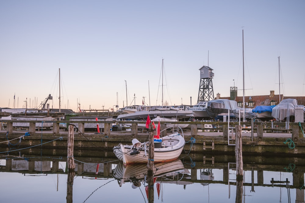 a small boat is docked at a pier