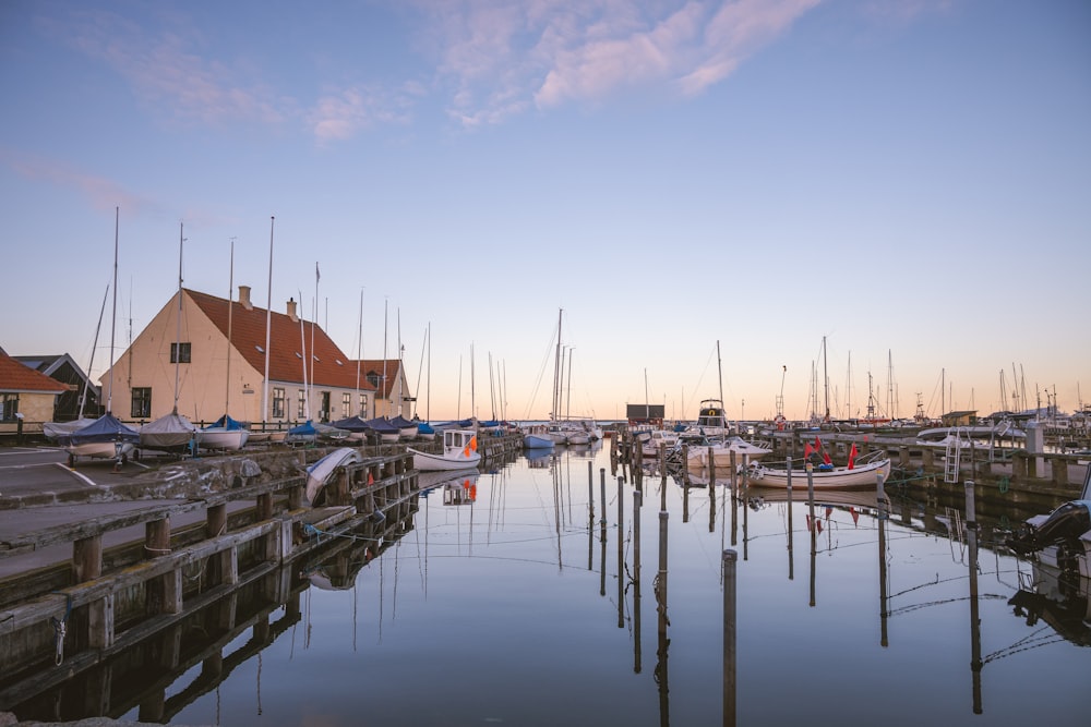 a harbor filled with lots of boats next to a building