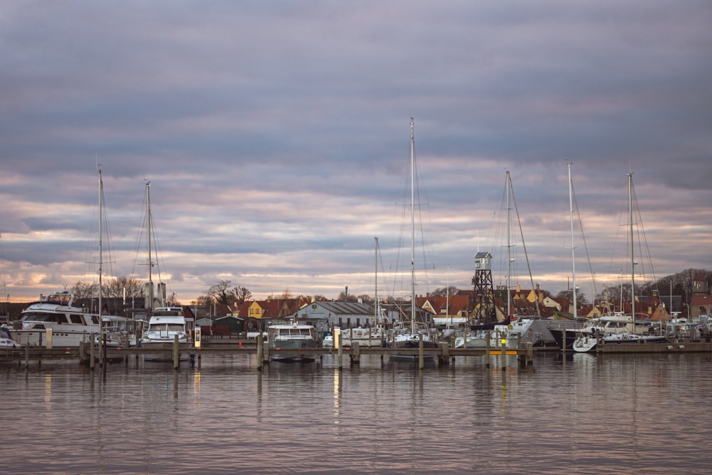 a harbor filled with lots of boats under a cloudy sky