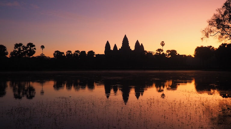 Sunrise view over the ancient Shore Temple in Mahabalipuram with golden light reflecting on the sea.