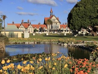a large house with a pond in front of it