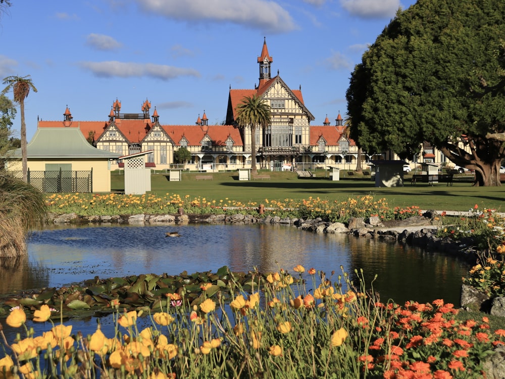 a large house with a pond in front of it