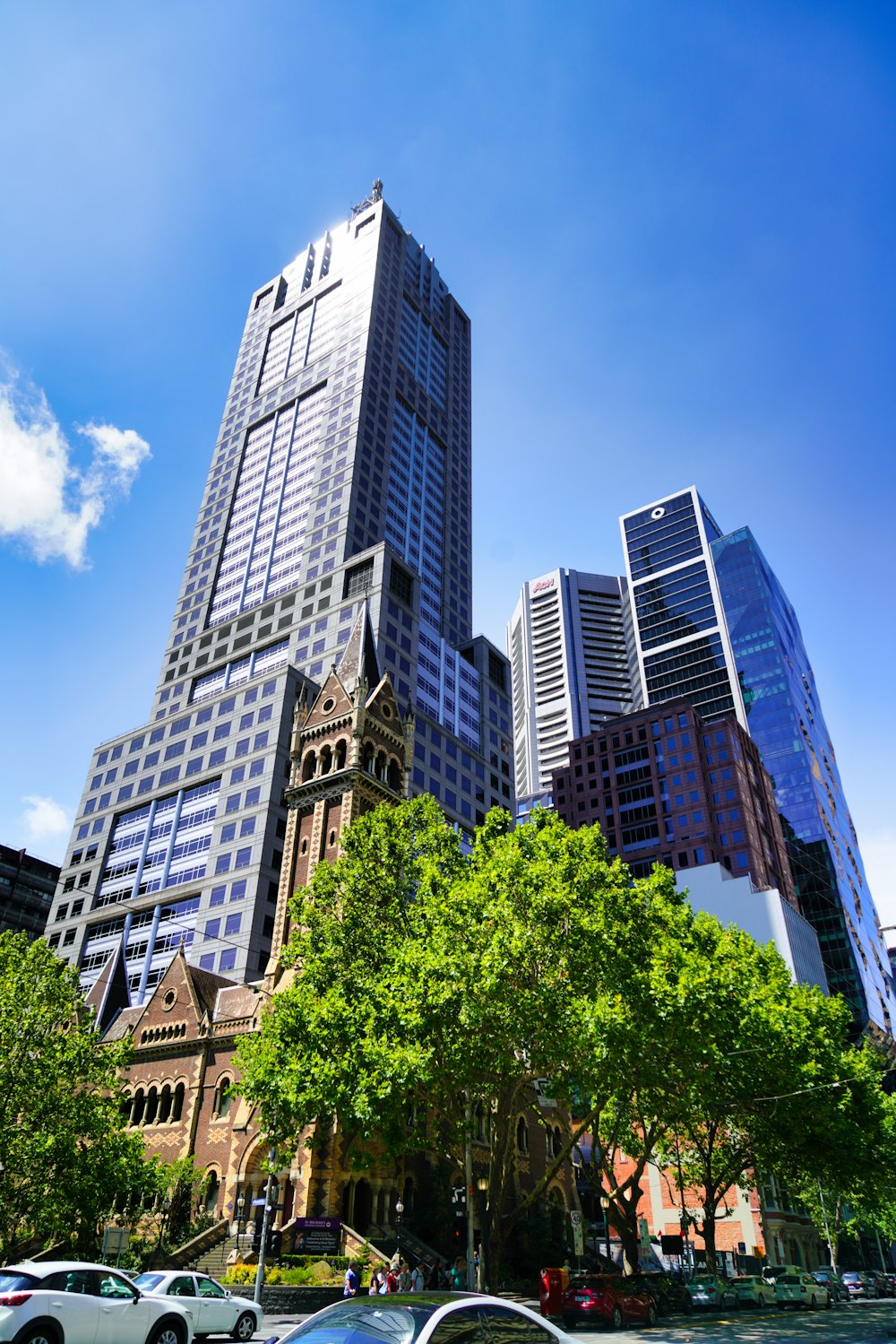 a group of cars parked in front of tall buildings