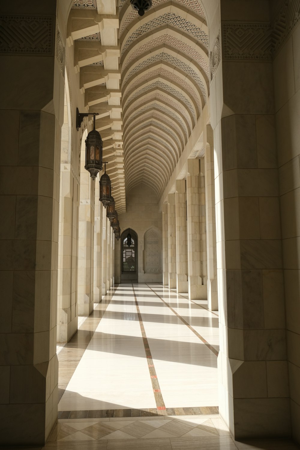 a long hallway with a clock hanging from the ceiling