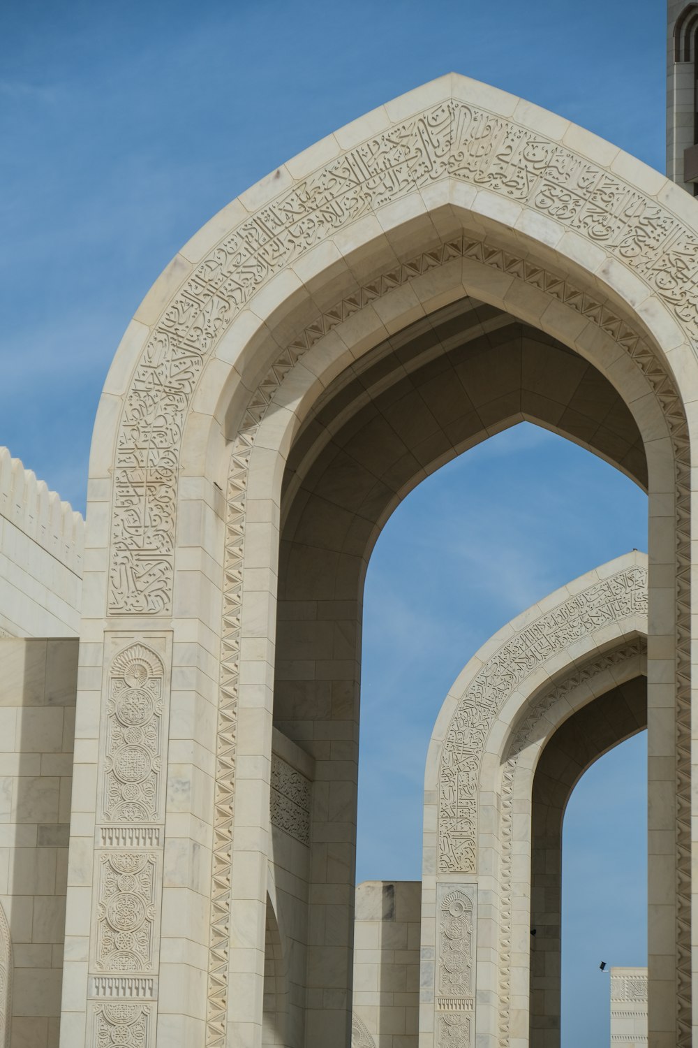 a couple of archways with a clock tower in the background