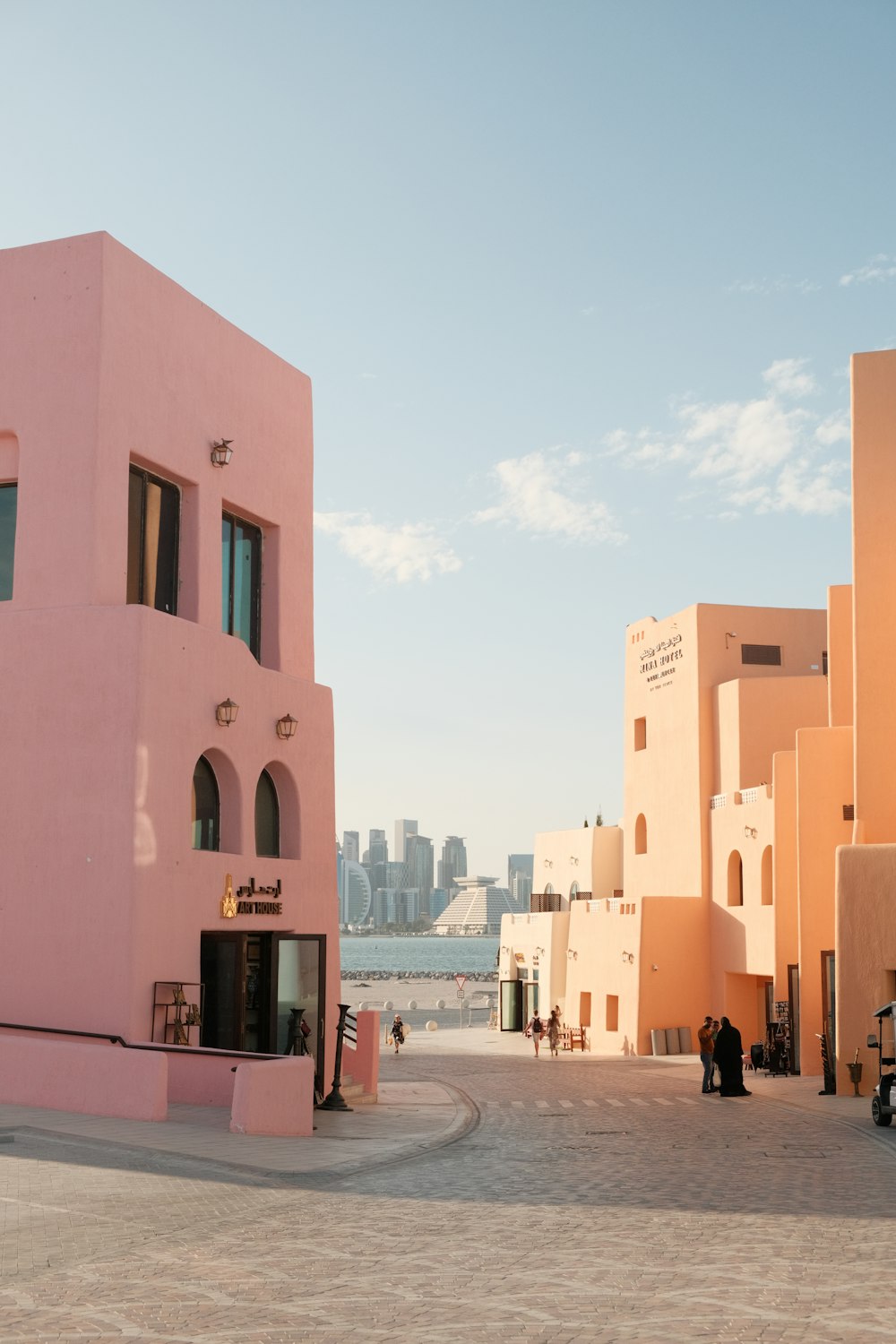 a pink building with a city in the background
