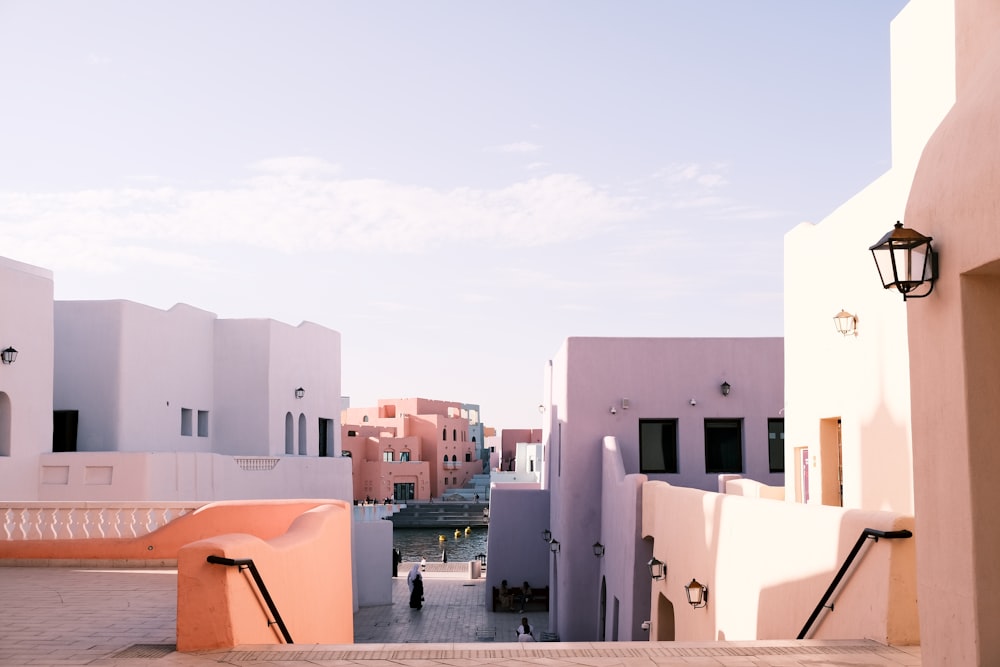 a person walking down a walkway between two buildings